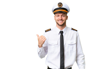 Airplane pilot man over isolated background pointing to the side to present a product © luismolinero