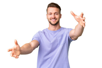 Fototapeta premium Young handsome caucasian man over isolated chroma key background presenting and inviting to come with hand
