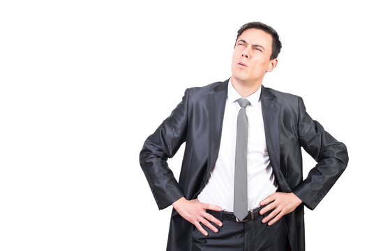 Focused confident man in elegant suit squinting eyes while thinking over issue