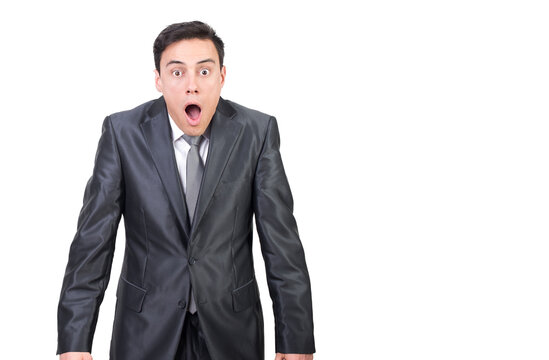 Shocked male in suit looking at camera with astonished face expression and opened mouth