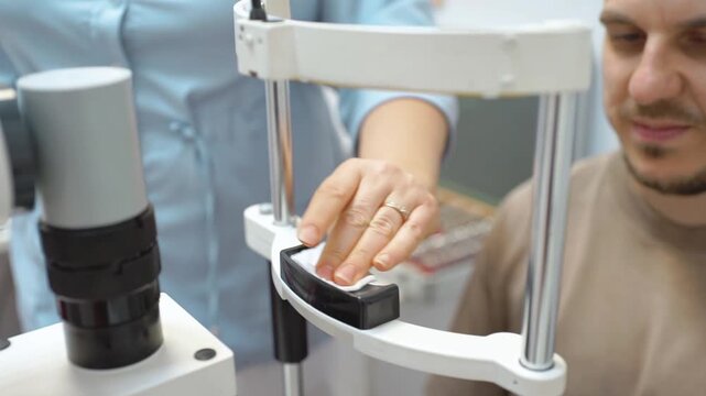 An ophthalmologist disinfects a medical device before examining a patient's vision. Vision check.