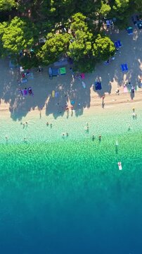 Vertical aerial view of Punta Rata beach and turquoise sea in Brela Croatia