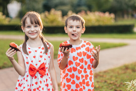 Children Enjoy Summer Treats While Celebrating Valentine's Day With Heart-Themed Outfits and Smiles at a Park