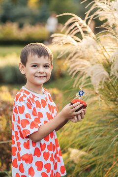 Two Children Enjoying a Summer Day in the Park, Sharing Moments of Love and Friendship With Heart-Themed Items
