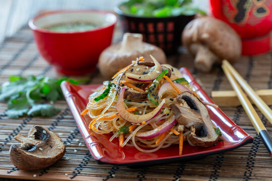 Close up stir-fried glass noodles with mushrooms.