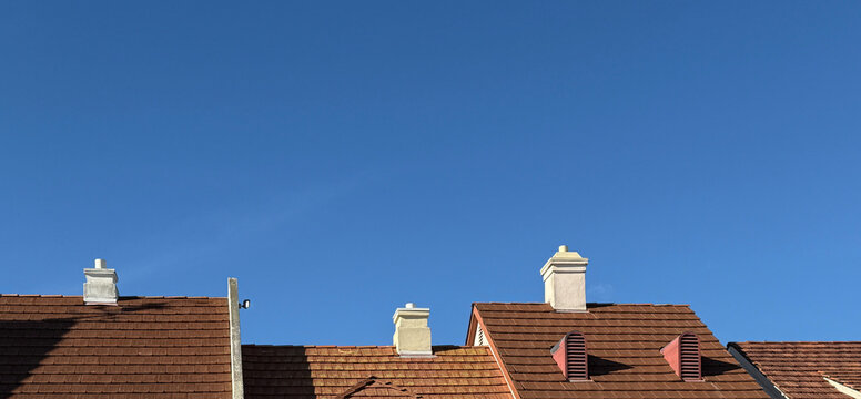 Danish Style Roofs and Chimneys under blue sky