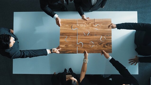 Top view of skilled businesspeople hand bring and fill the last jigsaw piece together. Group of project manager complete puzzle or solving problem. Unity, teamwork, successful project. Directorate.