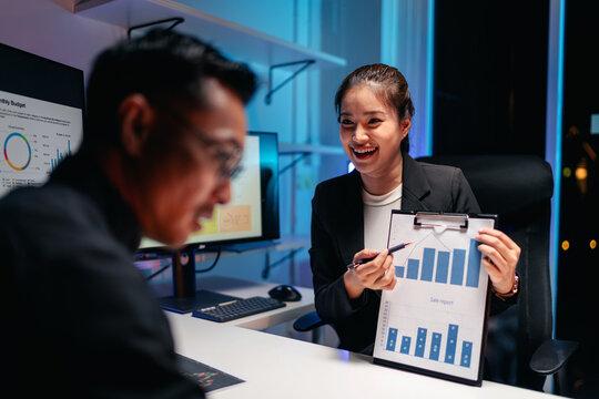 Dedicated Business Professionals Analyze Sales Report Data at Ni