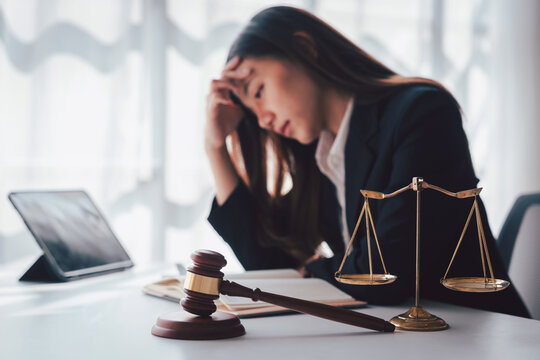 Stressed Asian Young Lawyer With Gavel Legal Scales At Desk Feel