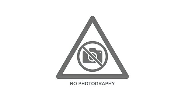 No photography warning sign triangle with camera icon.