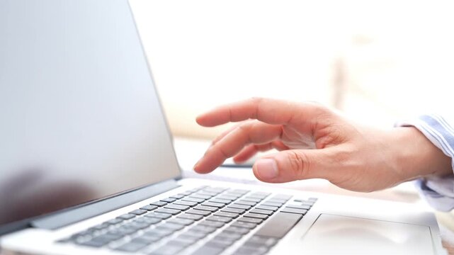 Business employee typing on laptop and pointing at mockup screen, digital technology workplace with hand gestures, online work, modern office, professional communication and digital transformation.