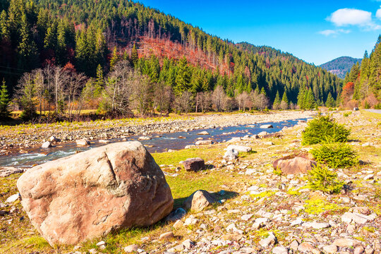 landscape with mountains, forest and a river in front. beautiful autumn scenery in the valley of Synevyr national park, Ukraine