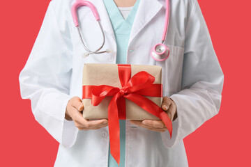 Obraz premium Healthcare appreciation and medical gift, doctor holding a present with red ribbon for patient care gratitude and hospital staff recognition