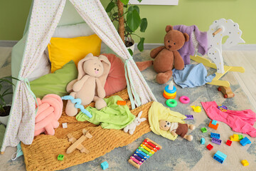 Childhood development and creative play, messy playroom with kids toys and teepee tent for imaginative learning and early education in home interior © Pixel-Shot