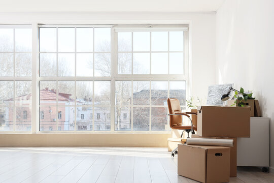 Workplace with moving boxes in office