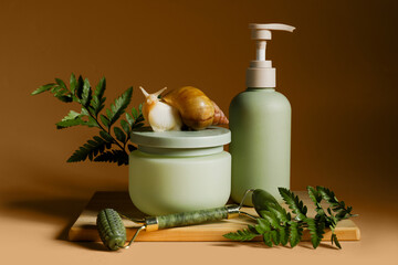 Wooden board, giant Achatina snail, facial massage tool, bottle and jar of cosmetic products on brown background, closeup © Pixel-Shot
