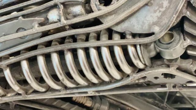 worn industrial closeup showing coiled tubing, ribbed support bars, and threaded connectors with rust, oxidation, and grime on cz, kladno, americka, 8.9.26