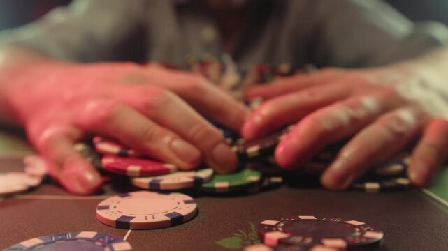 Casino player, Game of poker in casino, taking place with poker chips and cards on a green table betting chips, gambling place, roulette jack pot. All in bet game. 