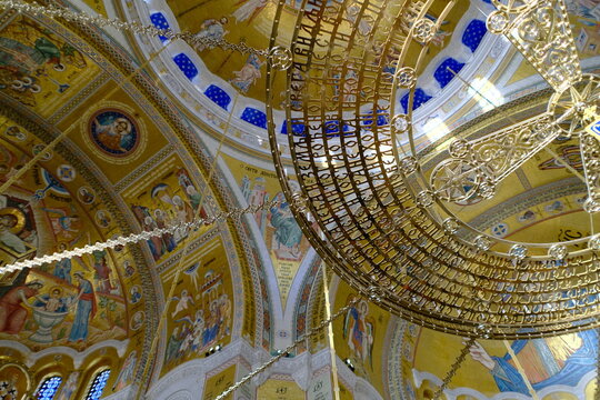 Chandelier with gold Cyrillic inscriptions inside the Church of Saint Sava in Belgrade, Serbia. Ornate chandelier featuring gold Cyrillic lettering inside Saint Sava Cathedral