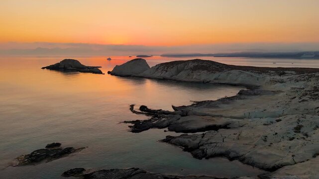 Beautiful orange and red sky in the early morning before sunrise on the Greek island Milos in Greece. 