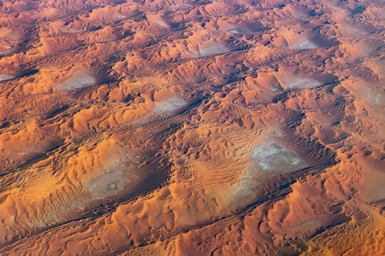 Oval salt pans among sculpted Sahara dunes