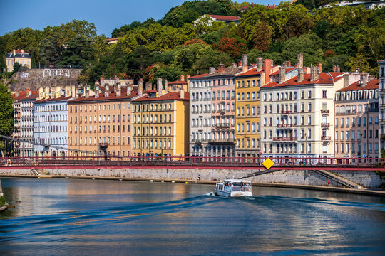 Sa&ocirc;ne River waterfront with Passerelle Saint-Vincent and tourist boat in Lyon, France