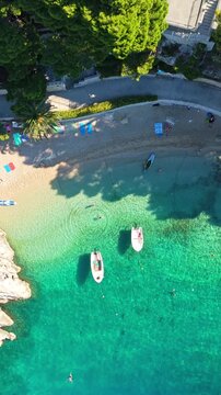 Vertical aerial view of Punta Rata beach and turquoise sea in Brela Croatia