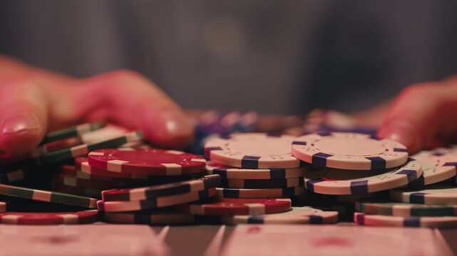 Casino player, Game of poker in casino, taking place with poker chips and cards on a green table betting chips, gambling place, roulette jack pot. All in bet game. 