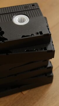 Vintage VHS cassette tapes stacked on floor