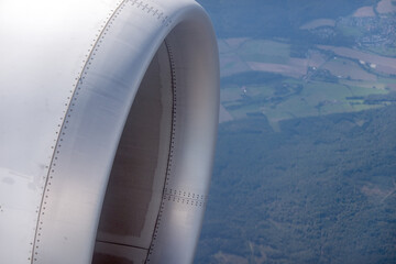 View of an airplane engine with landscape seen from a high altitude during daytime flight © Jill Dundee