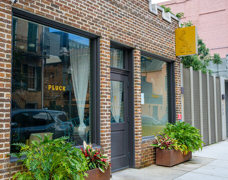 New Orleans, LA, USA - September 12, 2026: Pluck Wine and Bar Restaurant on Girod Street in the Central Business District