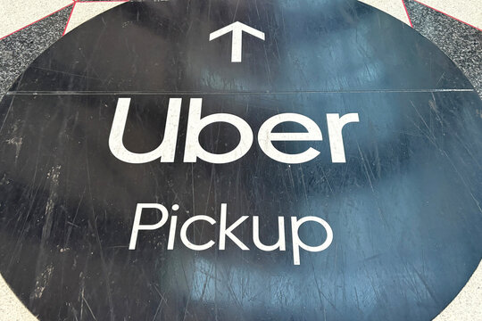 A sign at Chicago O'Hare International Airport pointing travelers towards Uber taxi pickup. in Chicago, Illinois on September 12, 2026.