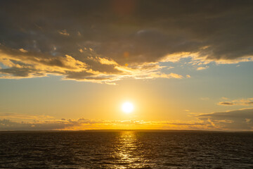 Fototapeta premium the water surface of a river or lake with sun glare at sunset