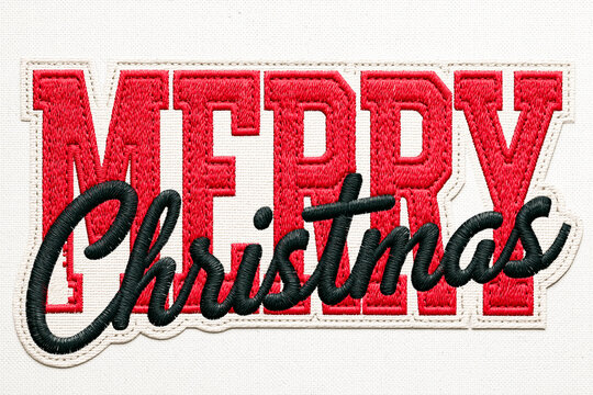 Close up shot of a high quality machine embroidery patch featuring the words "Merry Christmas" on a white canvas background, with bold red blocks for "MERRY" and black cursive script for "Christmas"