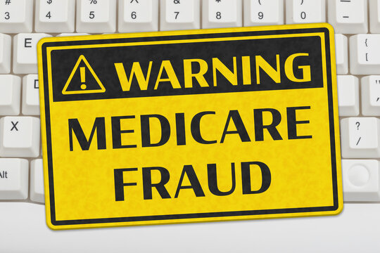 Medicare Fraud yellow warning sign on a computer keyboard