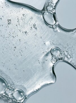 Close-up of a surface with multiple bubbles scattered across it. the bubbles are of different sizes and shapes, with some being larger and some being smaller.