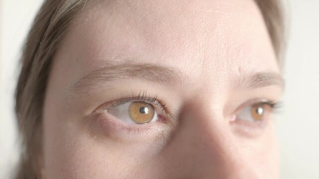 intense hazel eyes close-up, girl 25-30 years old, human eye looking to side, vision examination, myopia, eye fatigue, color perception