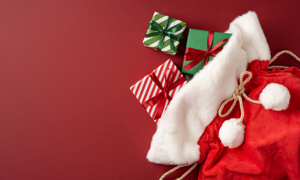 Santa Claus presents and red gift sack with green and striped wrapped boxes for Merry Christmas on banner backdrop with mockup