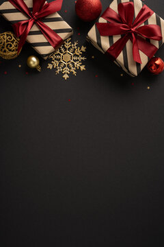 Elegant Christmas gift vertical composition with red ribbon, gold ornaments and Merry Christmas Happy New Year message