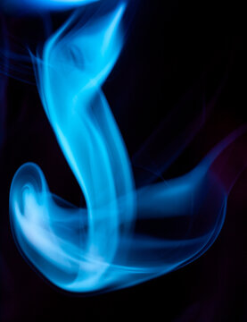 Smoke swirl in shades of blue against a dark background