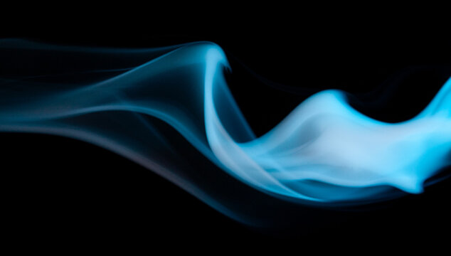 Smoke swirl in shades of blue against a dark background