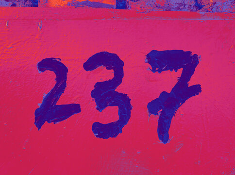 Hand drawn number 237 on garage door. Digits on a textured surface, with a neon fluorescent color palette and weathered details