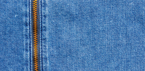 Blue denim fabric texture with vertical metal zipper for fashion background © agrus