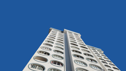 Perspective view of modern residential tower against blue sky in Costa da Caparica Portugal © Nadia
