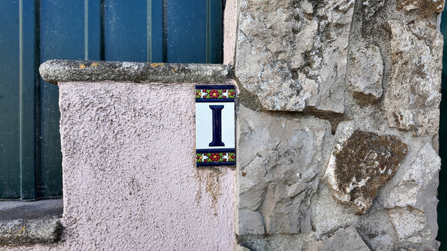 Traditional ceramic house number on stone wall in Costa da Caparica Portugal