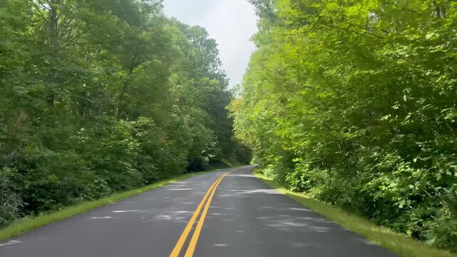 Driving along the scenic and popular Blue Ridge Parkway in the mountains of North Carolina near the town of Blowing Rock. 