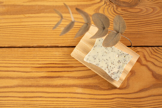 Natural herbal soap with scrub. Handmade soap bars on a wooden background. Space for text. 