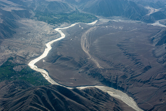 Aerial view of the gleaming Indus river winding through Ladakh mountains