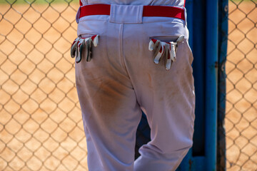 Detail of a baseball player's uniform with batting gloves in pockets