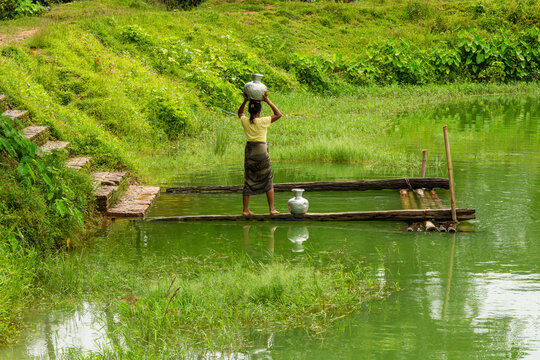 Local woman carrying water from a lake, Mrauk U, Myanmar.